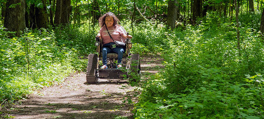 The Minnesota Department of Natural Resources offers all-terrain track chairs at selected sites. The battery-powered chairs give visitors with mobility disabilities a chance to explore state park trails that cannot be accessed using a regular wheelchair. (Photo courtesy of DNR)