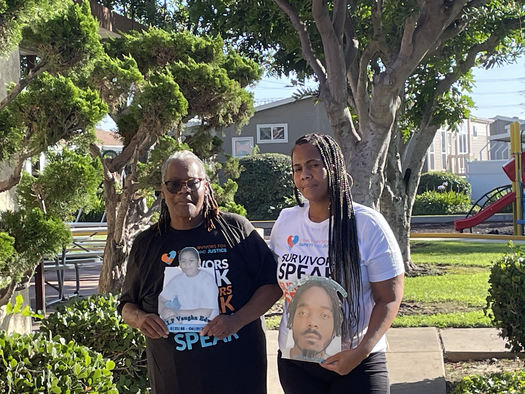 The data shows that victims of youth crime rarely receive full financial restitution. The Edwards family holds photos of lost loved ones at a picnic for crime survivors in Los Angeles last weekend. (LaNaisha Edwards)