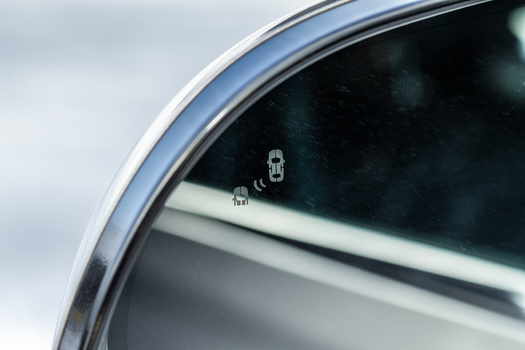 A blind spot monitoring system can help a driver avoid a collision. (Roman/Adobe Stock)