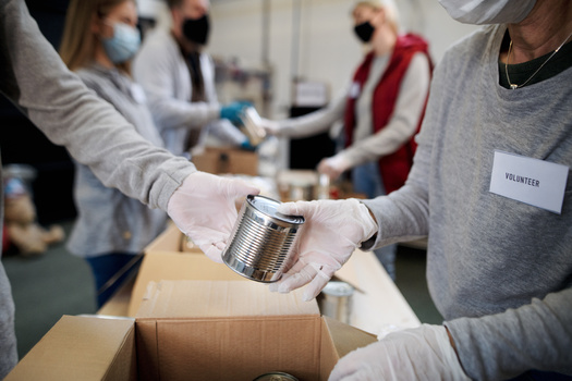 Washington state food banks are expressing concern about the drop in volunteers since the height of the pandemic. (Halfpoint/Adobe Stock)