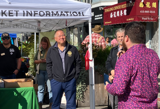 Assemblyman Phil Ting, D-San Francisco, speaks with Andy Naja-Riese of the Agricultural Institute of Marin at the Clement Street Farmer's Market in San Francisco. (Felice Thorpe)