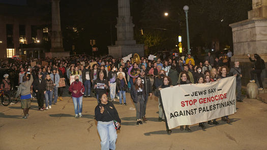 Jewish Americans hold up signs, including 
