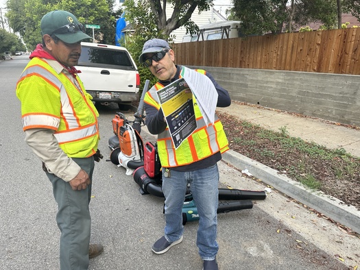 A landscaper learns about the capabilities and benefits of electric blowers. (American Green Zone Alliance)