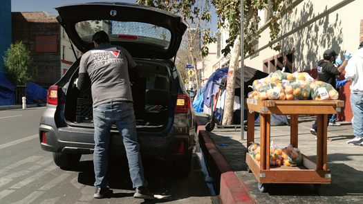 A worker from the With Love Market & Cafe drops off produce at Skid Row People's Market in Los Angeles. (L.A. Food Policy Council)