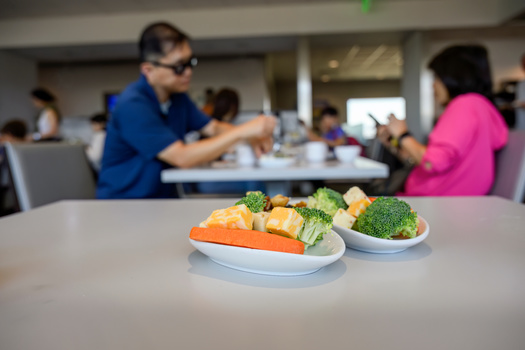 If your flight is delayed this holiday travel season, experts recommended people with chronic health conditions pack or seek out airport vendors selling healthy snacks. They said it can help reduce the risk of a health problem during your trip. (Adobe Stock)