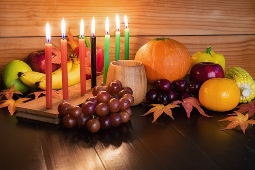 The seven candles in the kinara hold distinct meanings. Red reflects the struggle of Africans, green represents hope and the future, and black represents the African culture. (Adobe Stock)
