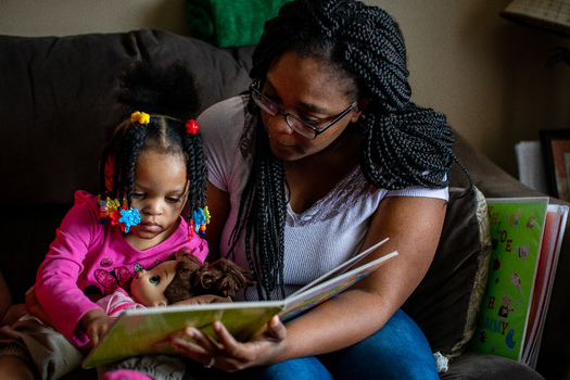 Parents are the first and most important teachers for their children. As part of the Early Steps to School Success program, a mother reads with her daughter at home. (Save The Children) 