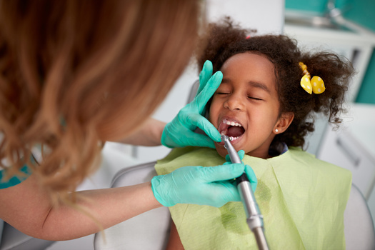Studies indicate that fluoride varnish can prevent about one-third of cavities in baby teeth. (Lucky Business/Adobestock)