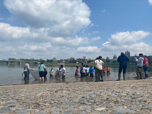 Chesapeake Bay Foundation educators, with students on a field trip, explore the Susquehanna River at City Island. The Capitol building is in the background. (Chesapeake Bay Foundation) 