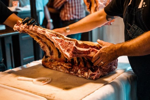 Grass-fed beef is prepared for serving at an industry event called the Meat Summit. (Roots of Change)