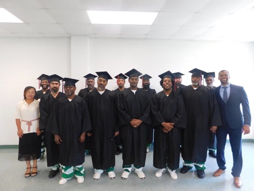 Prison-to-College Pipeline Program Director Patrick Alexander, far right, and PTCPP teaching assistant, Juyoun Jang, far left, celebrate with PTCPP students who completed the Summer 2022 course titled, 