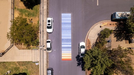 The Los Angeles neighborhood of Pacoima was covered in over 700,000 square feet of reflective pavement coating in the summer of 2022. Murals were painted on some of the covered areas. (GAF)