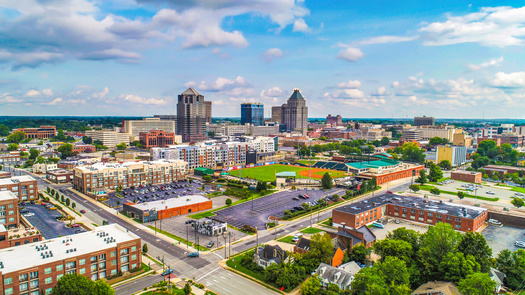 Revolution Mill is a former textile factory, spanning 45 acres about two miles outside downtown Greensboro. The 800,000-square-foot development features shops, offices, restaurants and apartments, and 2005 Revolution Mill, a $38 million mixed-use commercial and residential project. (Adobe Stock)