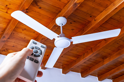 Using a ceiling fan can reduce air conditioning costs by up to 30% when the fan is circulating counterclockwise. It pushes cooler air downward, creating a cooling effect. (Adobe Stock)