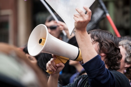 Communications Workers of America members across the country will hold up signs at work today to show their solidarity with workers on strike. (Adobe Stock)