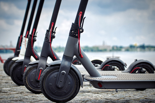 E-scooter companies say shared micromobility can be made safer if more people wear helmets, streets are properly maintained, and more cities add protected bike lanes. (Bondariev Volodymyr/Adobe Stock)