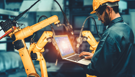 'Smart' robot arms are becoming a common sight in manufacturing facilities. Educational leaders say providing more training on artificial intelligence can better prepare students for systems using AI programming. (Adobe Stock)