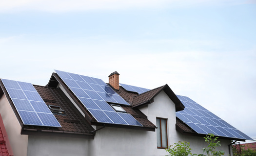Forty percent of the funds for climate projects in the Inflation Reduction Act must be spent in underserved communities. The SolarCorps helps low-income families install residential solar. (New Africa/Adobe Stock)