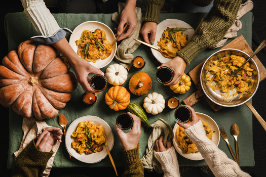 Economists suggest for a more budget-friendly holiday feast, consider hosting a potluck. Sharing dishes not only brings variety to the table but helps spread the costs among guests. (Adobe Stock)