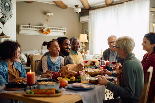 Economists suggest for a more budget-friendly holiday feast, consider hosting a potluck. Sharing dishes not only brings variety to the table, but helps spread the costs among guests. (Drazen/Adobe Stock)
