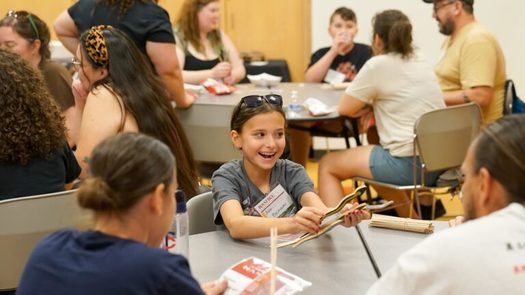 Ava Bruneau plays Ginebig: The Snake Game, a game of chance. Players roll or toss 