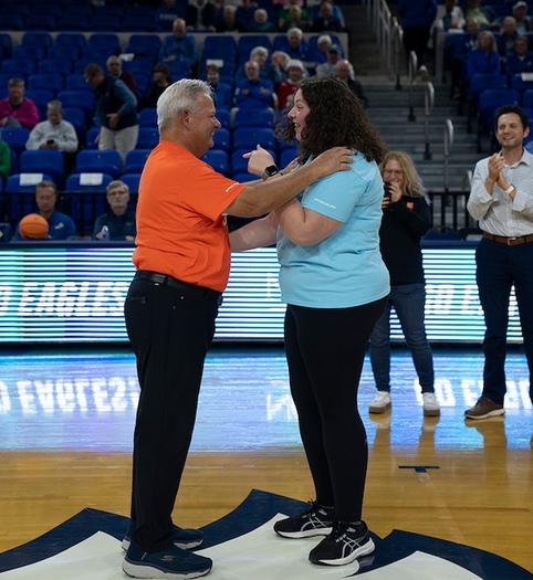 Florida Gulf Coast University student Zoe Horowitz meets the recipient of her stem cells, Kevin Mitchell, for the first time at an women's basketball game. (Sarah Passey)