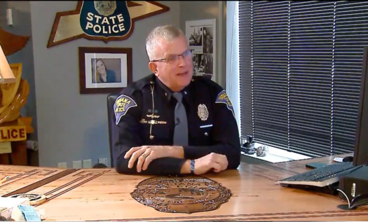 Retiring Indiana State Police Superintendent Doug Carter sits in his office behind a desk built by the Indiana State Department of Correction. (WISH-TV)