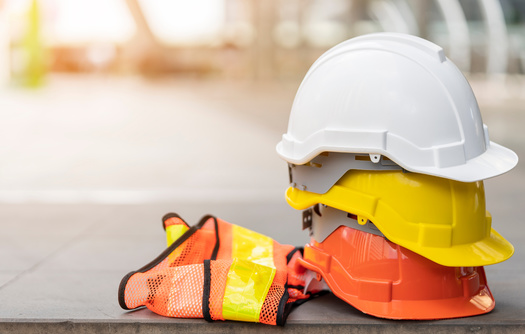 Federal officials said construction vests too small for larger workers could limit their mobility in a dangerous situation on a job site, one reason why they are moving forward with a new rule requiring such gear to properly fit all workers. (Adobe Stock)