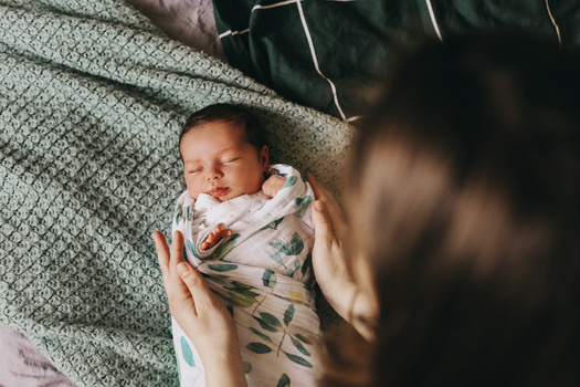 Thirteen states and the District of Columbia have laws providing paid family and medical leave programs for eligible workers, according to federal data. (Adobe Stock)