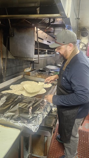 Volunteer Hector Silva of Hunger Action Los Angeles prepares burritos for distribution to fire victims in Pasadena, Calif. (Sara Donis)