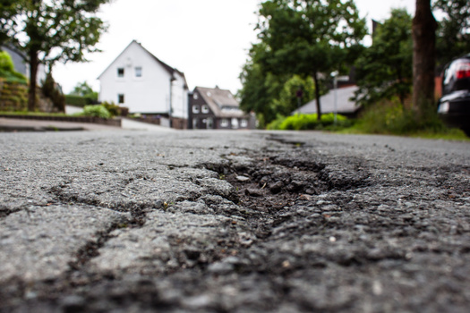 When corporate-sized farms gain a presence in rural communities, skeptics said the added economic activity can have side effects, such as larger trucks leading to deteriorated roads. (Adobe Stock)