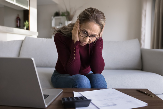 More than one in three older Americans who still owe debt from college live with a child or parent, according to New America. (Adobe Stock)