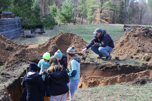Gregor Willms assists the Cedarburg High School team in the soil pit at Envirothon 2024. (Wisconsin Land and Water Conservation Association)