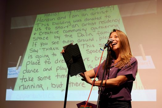 Ash Hanson reads a love letter to a crowd gathered at the YES! House as part of a residency with artist JJ Kapur. (Photo courtesy of Alana Horton)