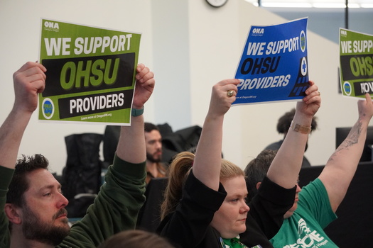 Advanced Practice Providers hold up signs during the OHSU Board of Directors' public session on April 25. (Oregon Nurses Association)