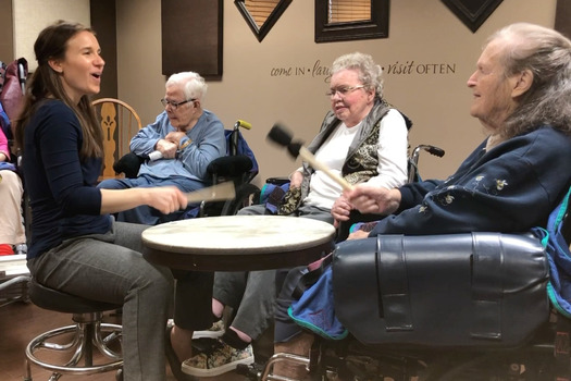 Board-certified music therapist Stephanie Johnson, left, works with older adults in a drumming circle through Music Speaks. Her work is part of a movement to bring more signing and music opportunities to people diagnosed with dementia. (Photo courtesy Music Speaks)