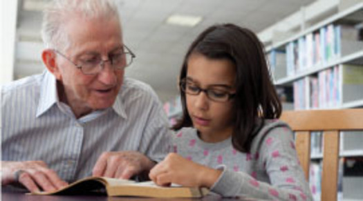 PHOTO: Grandfather reading to child