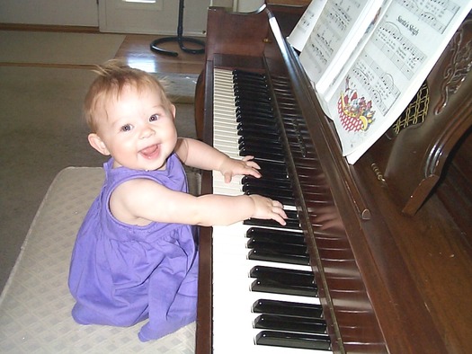 PHOTO: Child playing a piano. Photo credit: Deborah Smith