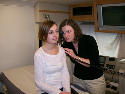 Dr. Tanya Page gives a routine health exam to a young patient in Outside In's mobile health van. Photo courtesy of Kelly Anderson.