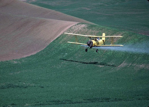 PHOTO: Aerial crop-spraying in northeast Washington. Photo credit: Ron Nichols, Natural Resources Conservation Service.