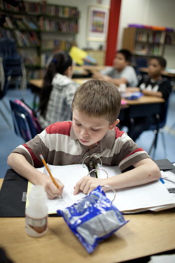 PHOTO: A student at Old Mill Middle School North in Millersville, MD, studies while enjoying school breakfast.