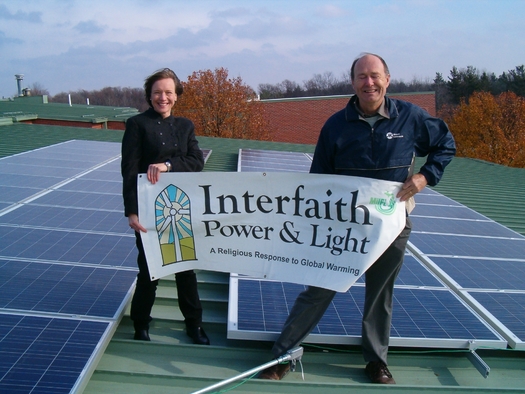 Julie Lyons Brinker and Dave Fredericks from MIFPL, standing on an Ann Arbor church roof. Photo credit: MIFPL
