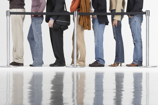 PHOTO: Stylized shot of a row of people (legs only) in line to vote. 