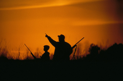 PHOTO: Man and youth hunting at sunrise. Photo credit: USFWS