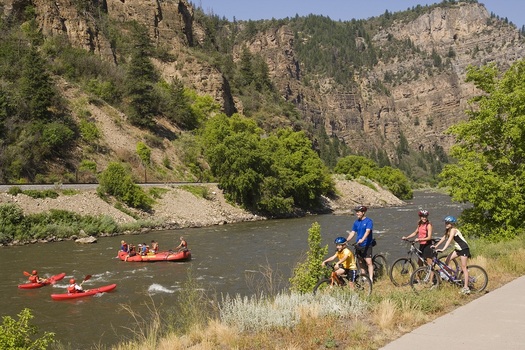 PHOTO: Bikers and rafters enjoy Glenwood Canyon, along the Colorado River. Courtesy Glenwood Springs Chamber Resort Association.
