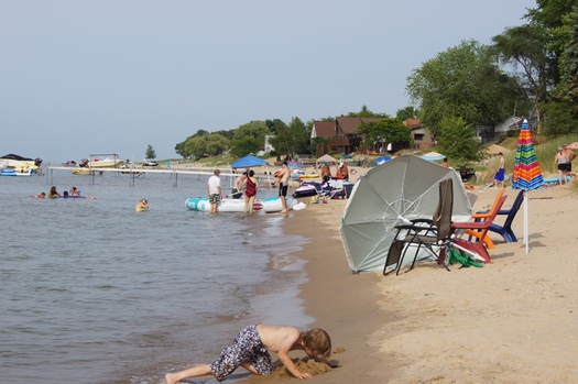 Millions of people flock to Michigan beaches in the summer. Recent cuts to environmental cleanup could threaten the quality of those beaches.