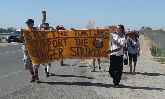 PHOTO: Supporters of the California prisoner hunger strike march outside Corcoran State Prison. Photo Credit: Urszula.