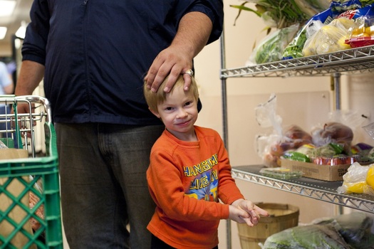 PHOTO: SNAP recipients will see food aid reduced this fall when a boost in benefits from the ARRA expires. Additional cuts proposed through the Farm Bill could further reduce benefits. Photo: boy at a food pantry. Credit: Jessie Gladin-Kramer.