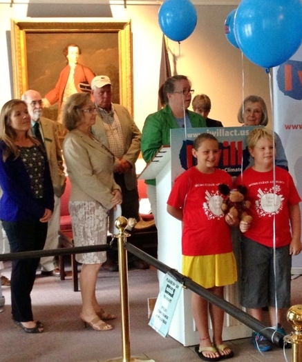 PHOTO: NH residents call for action on climate chance in Concord. Credit: Benton Strong