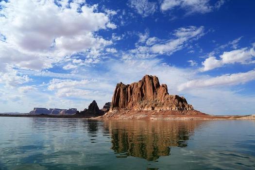 PHOTO: Gregory Butte, as seen from Lake Powell. The lake is as popular as a summer boating destination as it is a water source for the Southwest. Photo credit: Bob Moffitt, National Park Service.